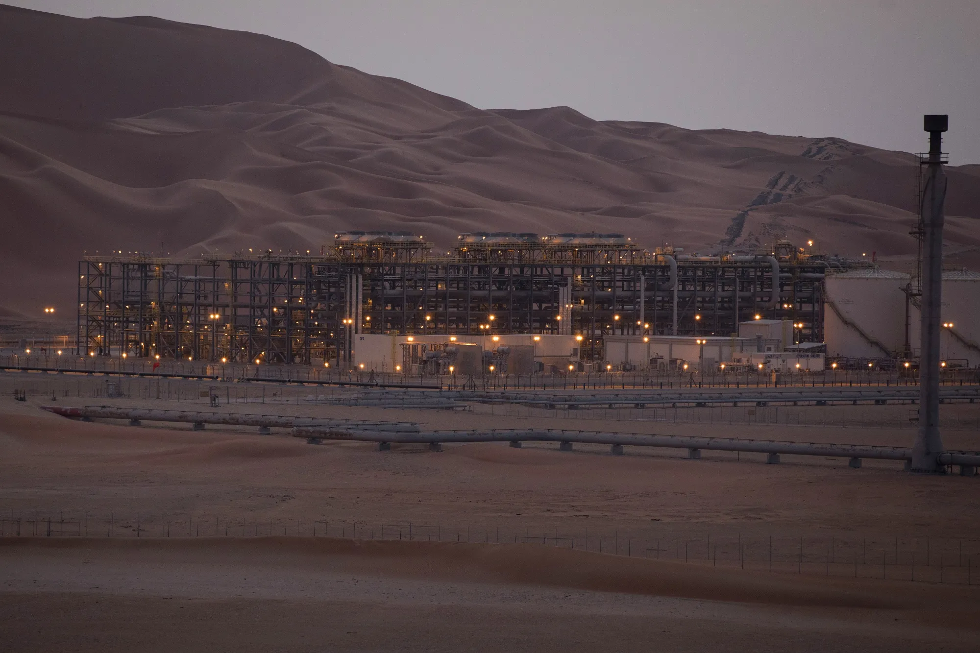 Lights illuminate the oil processing facility in Saudi Aramco's oilfield in the Rub' Al-Khali (Empty Quarter) desert in Shaybah, Saudi Arabia.