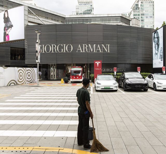 Custodian cleaning in upscale retail neighborhood in Beijing, China.