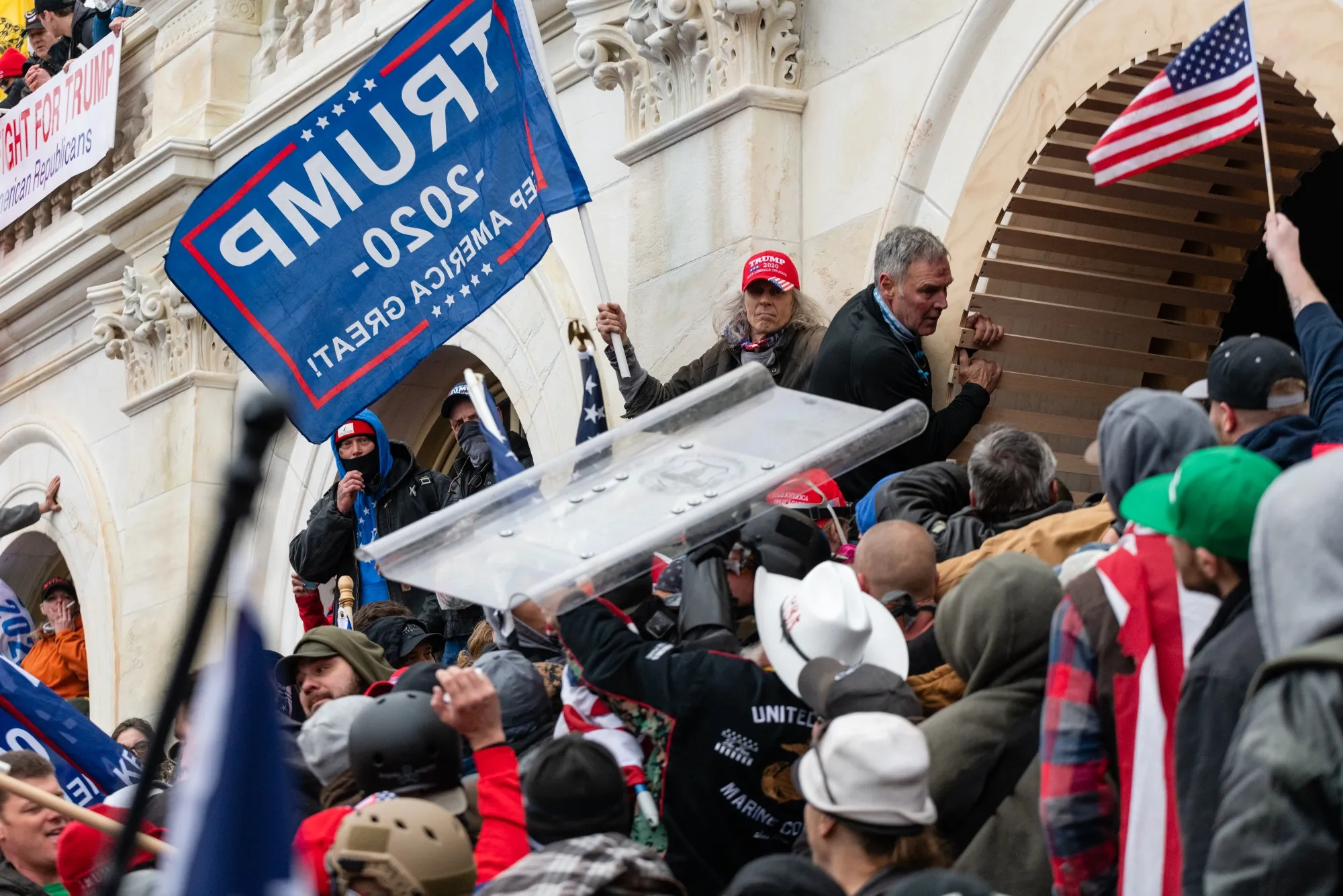 Demonstrators steal a Metropolitan Police riot shield while attempting to enter the U.S. Capitol building during a protest in Washington, D.C., U.S., on Wednesday, Jan. 6, 2021.