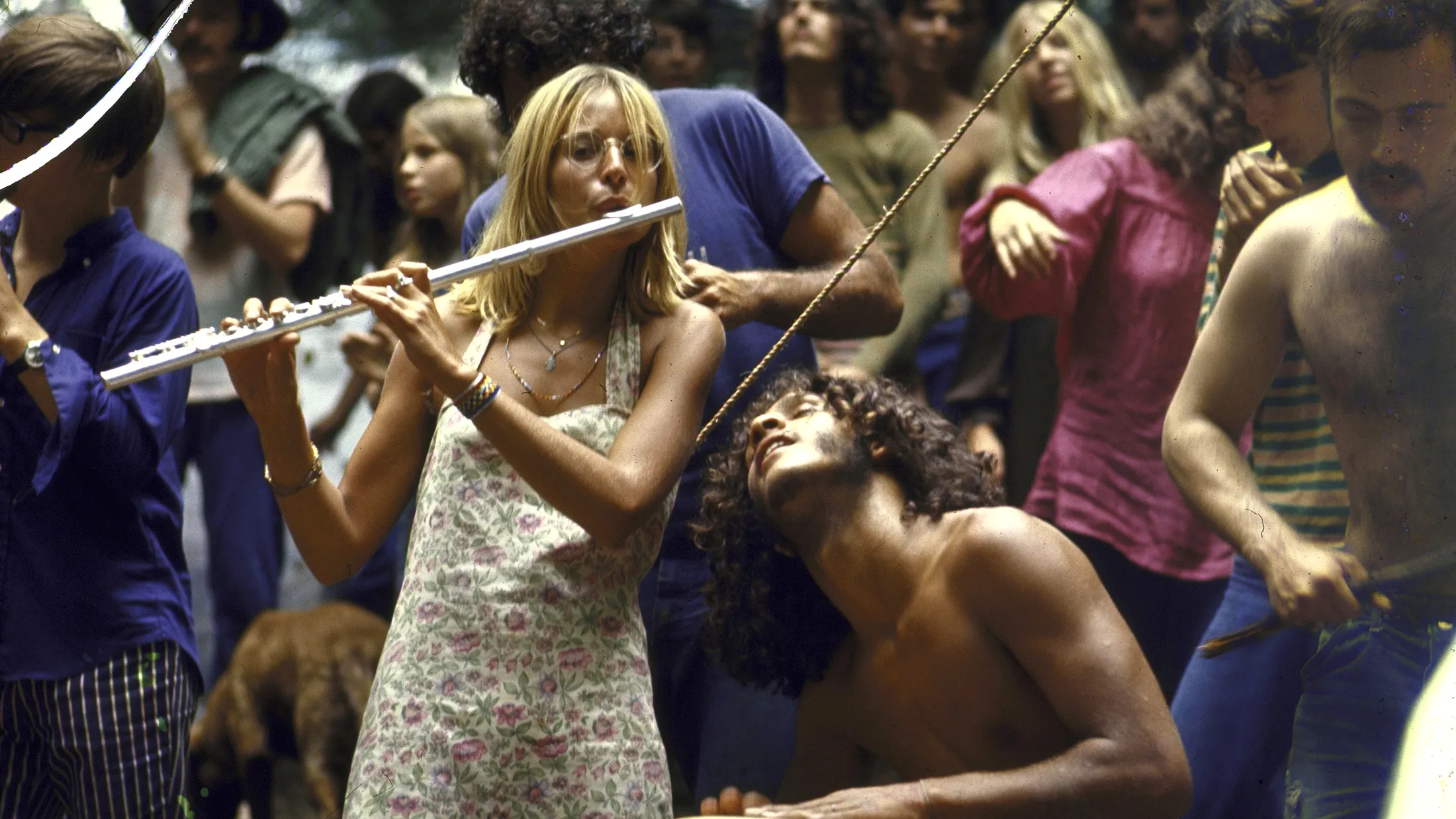Shirtless male drummer & dress-wearing f