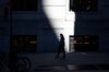 A pedestrian wearing a protective mask walks toward the New York Stock Exchange (NYSE) in New York, U.S., on Monday, Nov. 9, 2020.