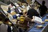 Employees sort packages at the UPS Chicago Area Consolidation Hub in Hodgkins, Illinois, on Dec. 5.