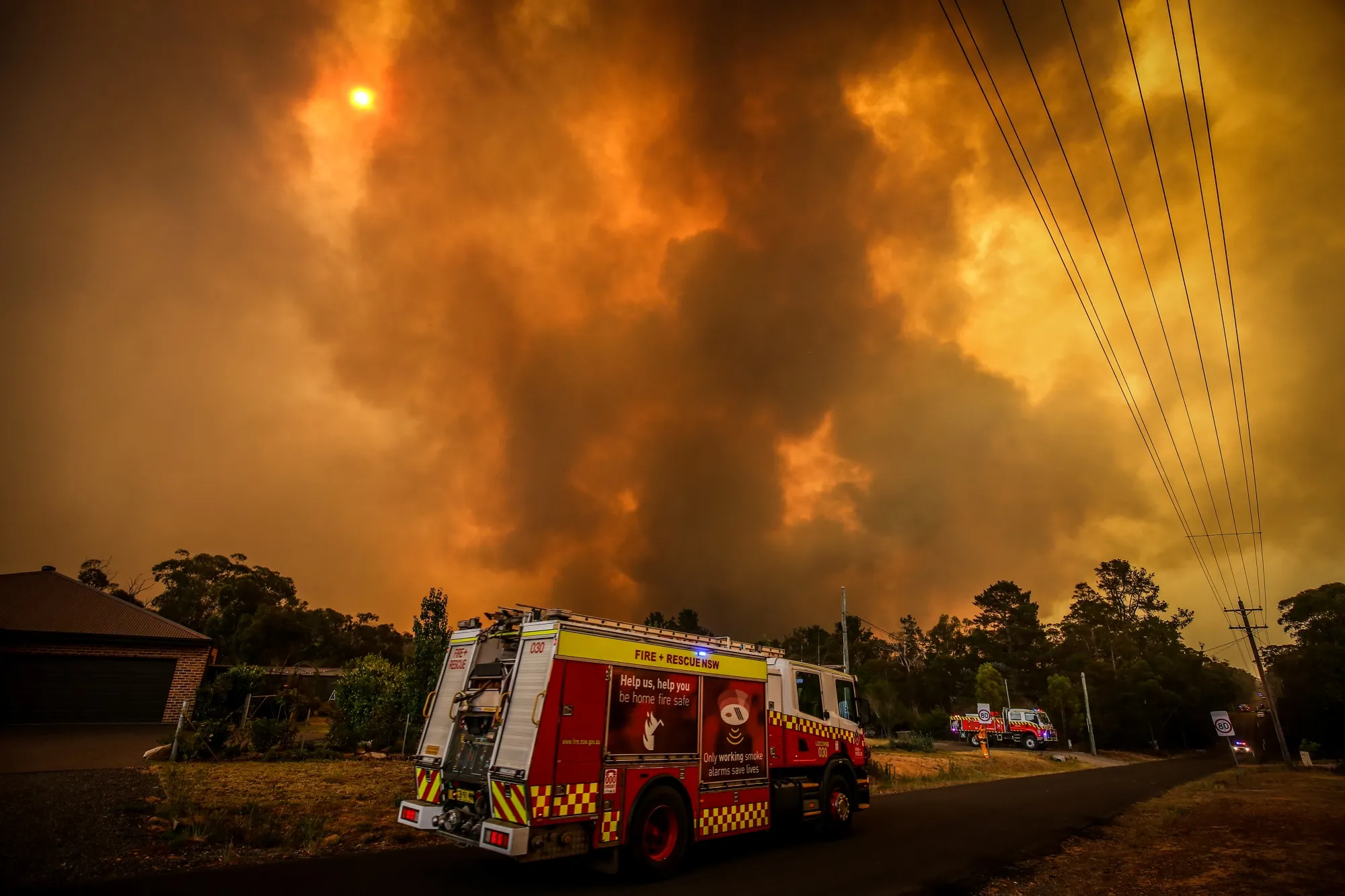 Firemen prepare as a bushfire approaches homes on the outskirts of the town of Bargo on Dec. 21.