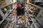 A warehouse employee picks groceries inside a Lavka store.