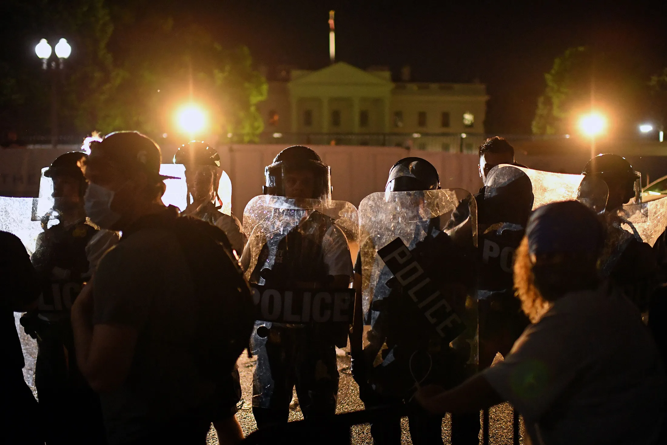 Protesters confront a row of police officers outside the White House in Washington, DC, on early May 30.