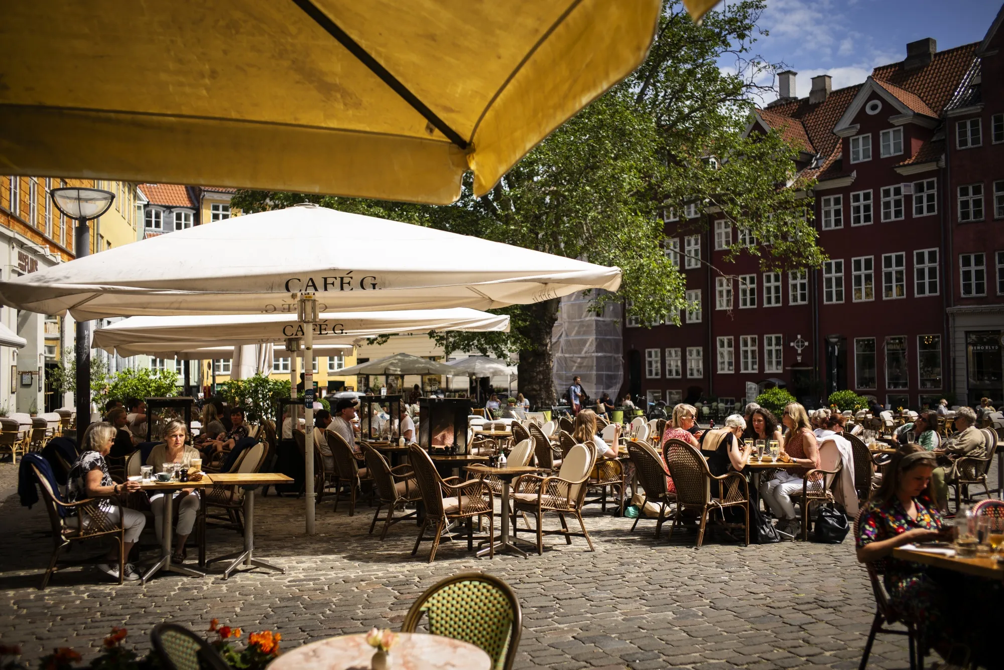 Cafe customers sit outside in Copenhagen on a&nbsp;June day.