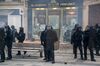 French riot police stand in front of destroyed shop windows on the Champs-Elysees in Paris on March 16.