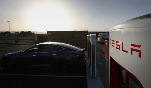 A Tesla Motors Inc. Model S P85D vehicle sits plugged in at a charging station in Nephi, Utah.