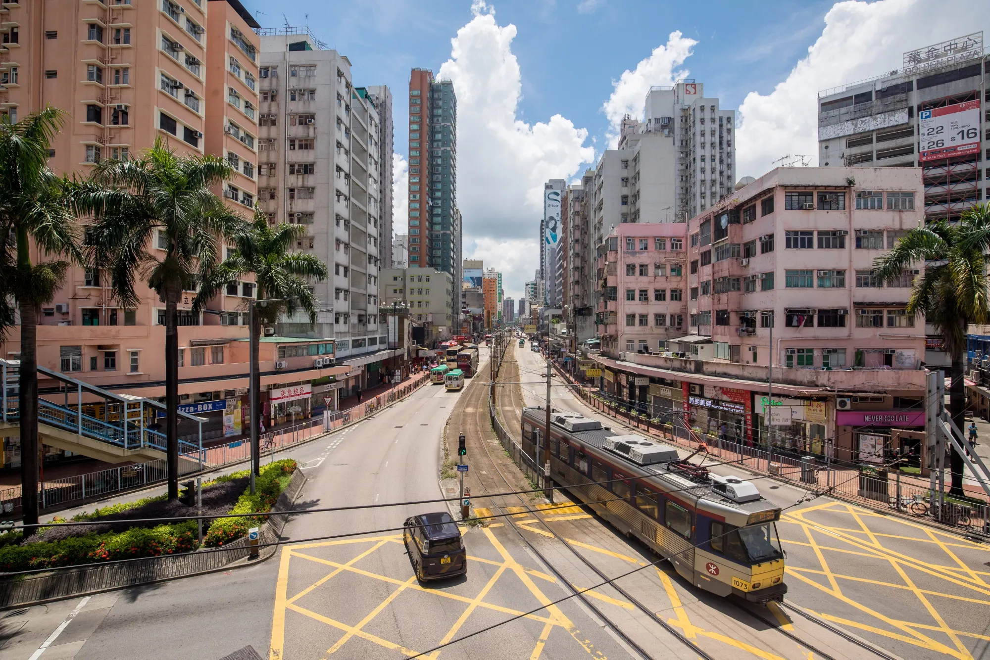 A light rail train travels through a street in the Yuen Long district, Hong Hong.