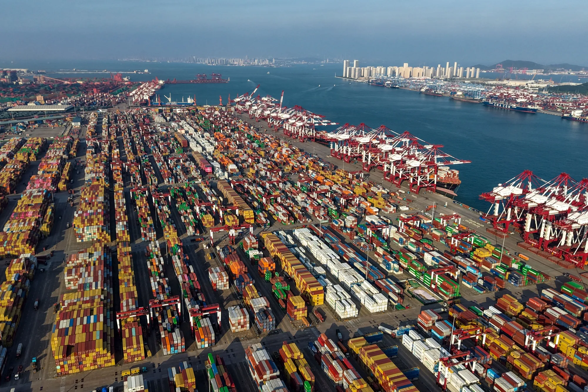 Containers and ships are seen at the port terminal in Qingdao, in China's eastern Shandong province on September 10, 2025. (Photo by AFP) / China OUT (Photo by -/AFP via Getty Images)