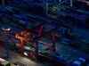Shipping containers sit stacked among gantry cranes at the Busan Port Terminal (BPT) at dusk in Busan, South Korea.