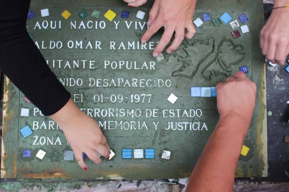 In Buenos Aires, handmade plaques laid into the sidewalk commemorate the "desaparecidos" who disappeared under the military dictatorship.