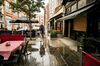 Empty tables in the rain outside an Italian restaurant near a closed-down pub in central London on Aug. 16, 2022.