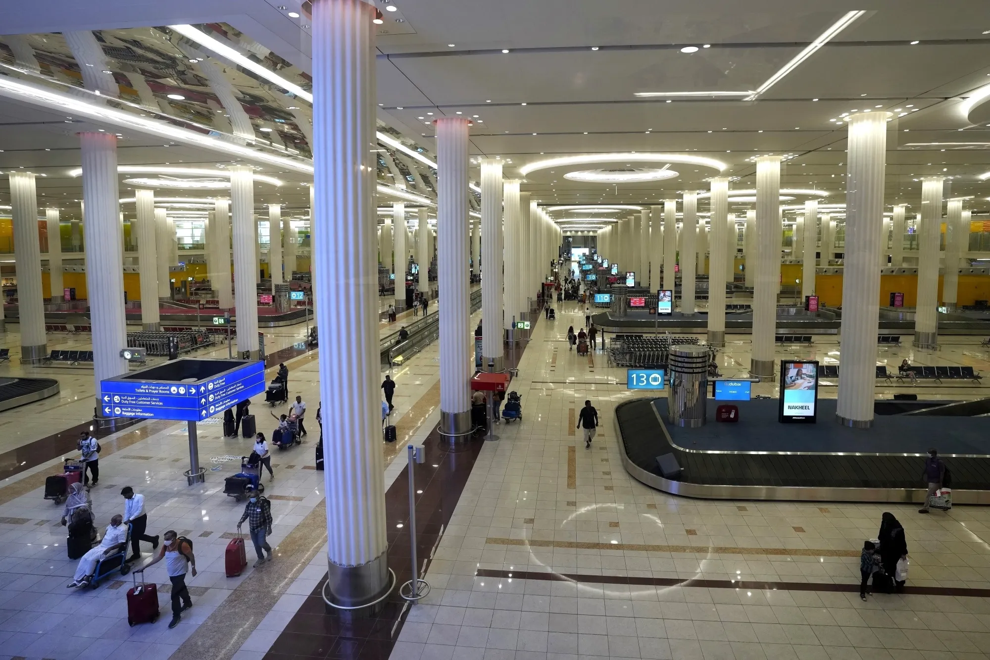 Passengers leave the baggage handling hall at the Dubai International Airport terminal 3, in Dubai, United Arab Emirates, on Oct. 25, 2022. The number of passengers flying through Dubai International Airport, the world's busiest for international travel, surged in 2023 beyond its total for 2019 — just before the coronavirus pandemic grounded global aviation, officials said Monday, Feb. 19, 2024. (AP Photo/Kamran Jebreili, File)