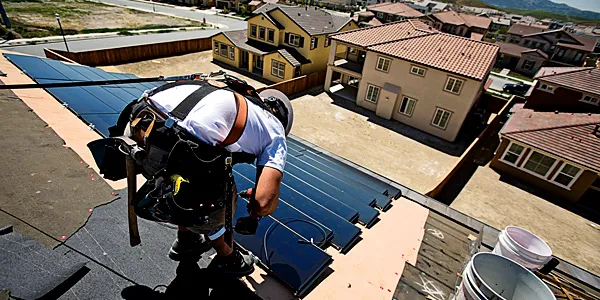 SunPower workers install solar panels on homes in California 