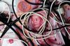 Cables sit on top of Chinese one-hundred yuan banknotes in an arranged photograph taken in Hong Kong, China, on Monday, April 15, 2019.