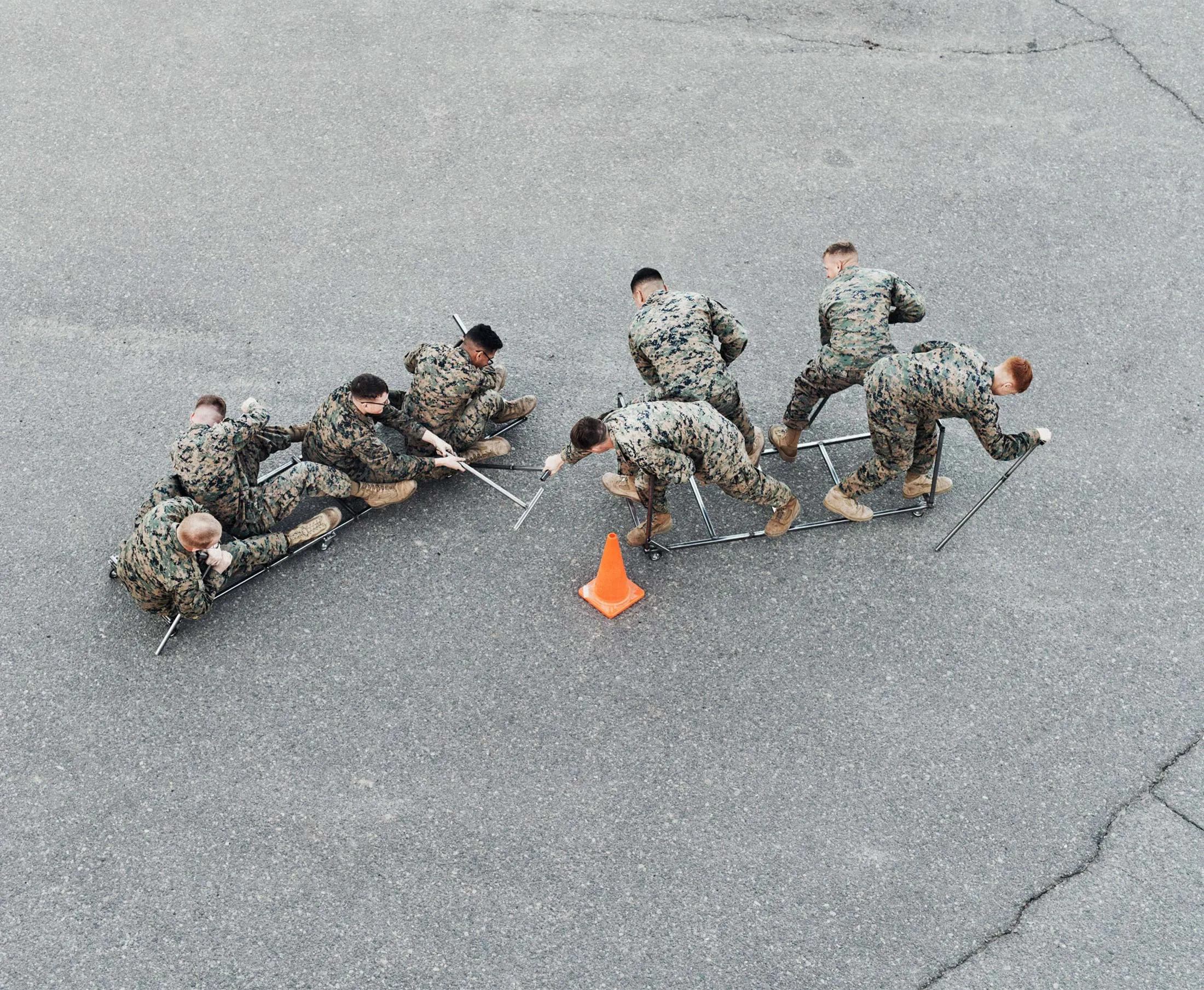 Marines race scrap-metal “urban canoes” across a Camp Pendleton parking lot.