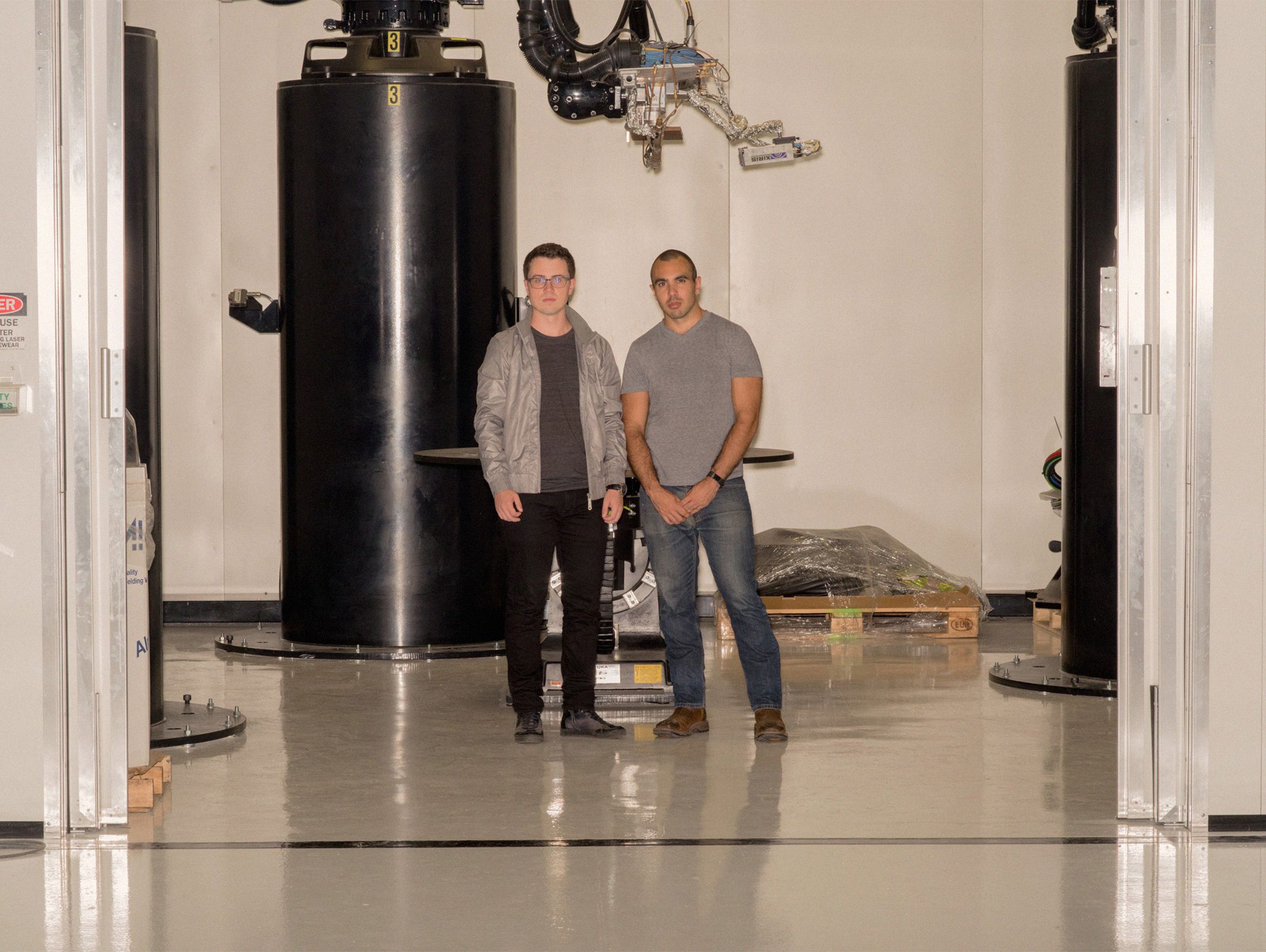 From left, Tim Ellis and Jordan Noone in front of their 3D printer at the Relativity Space headquarters outside Los Angeles.