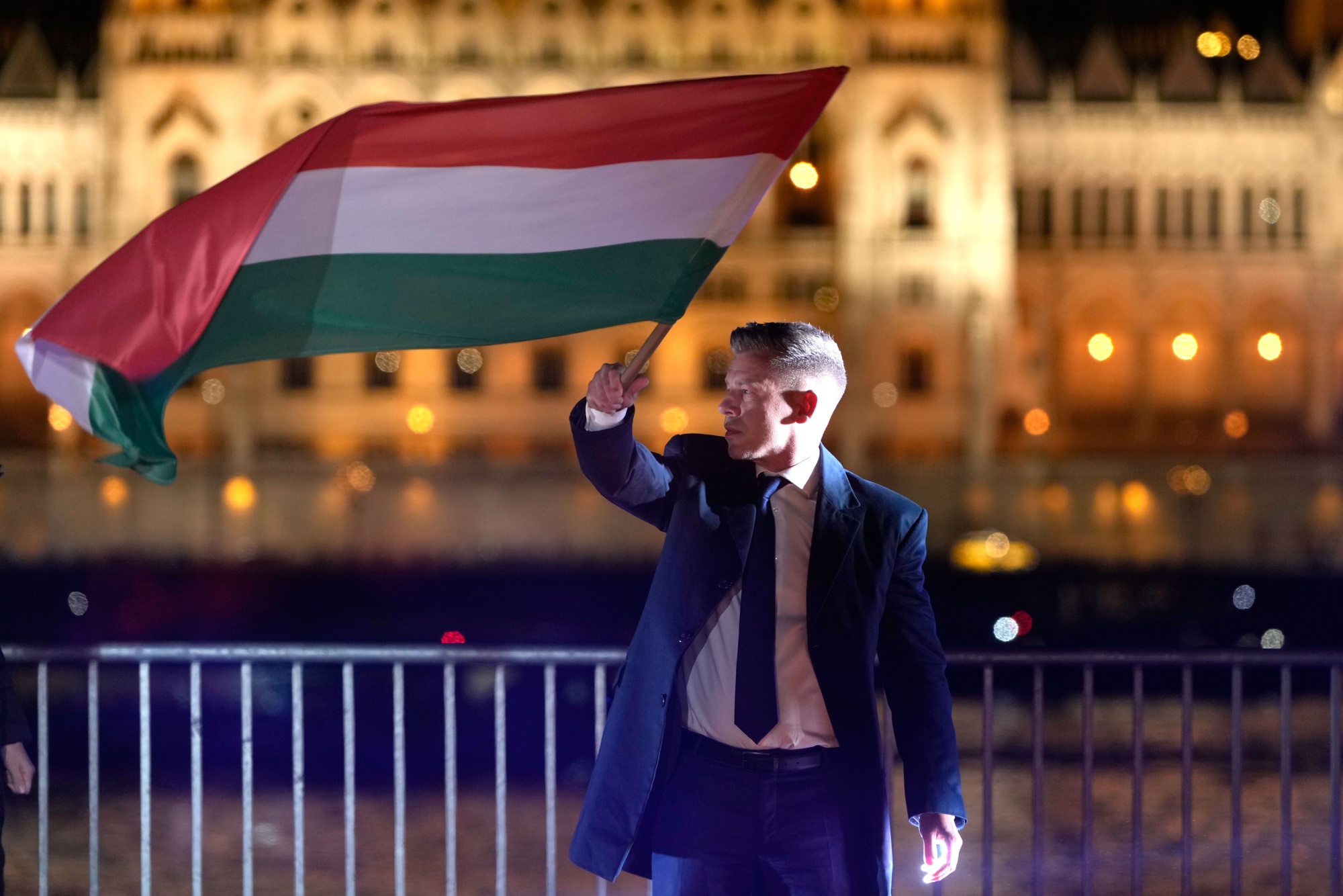 Peter Magyar, the leader of the opposition Tisza party, waves a national flag in Budapest on April 12.