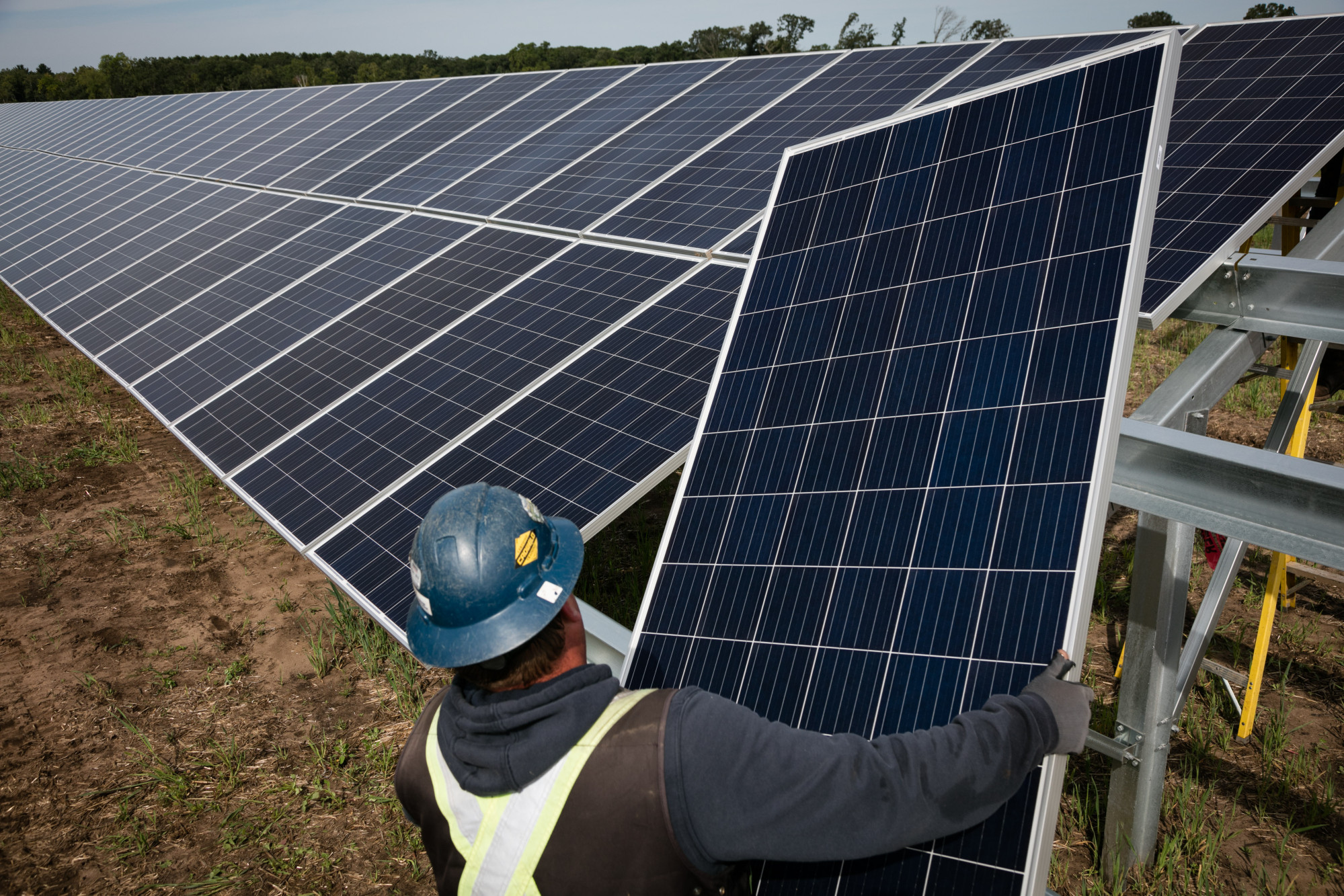 A worker installs solar panels&nbsp;in Athens Township, Minnesota.