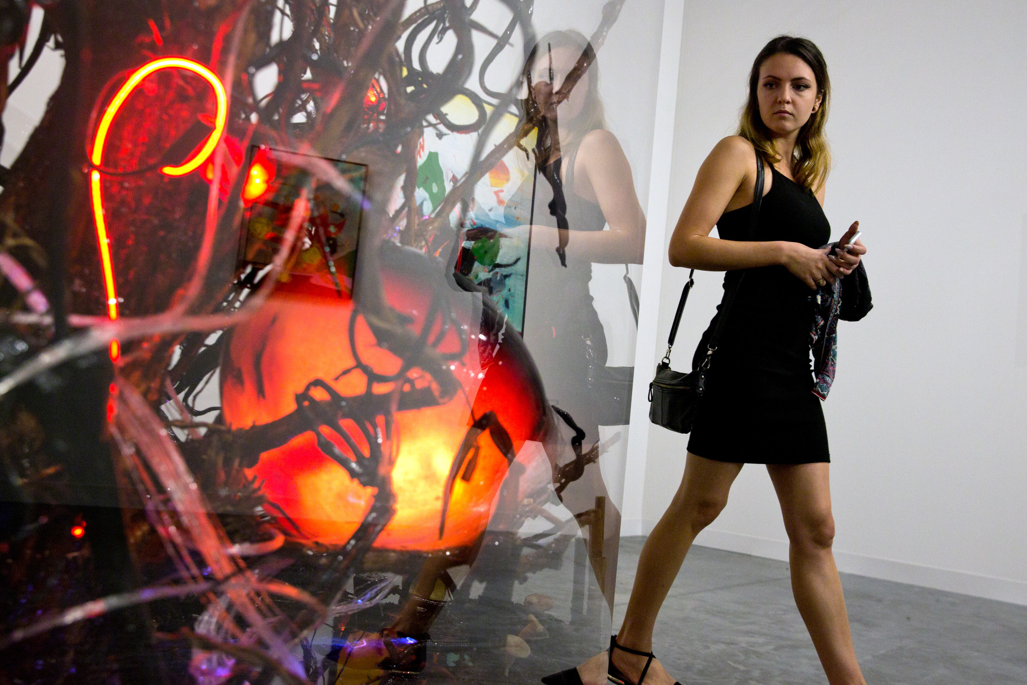 A visitor walks past an art installation&nbsp;during Art Basel Miami Beach.