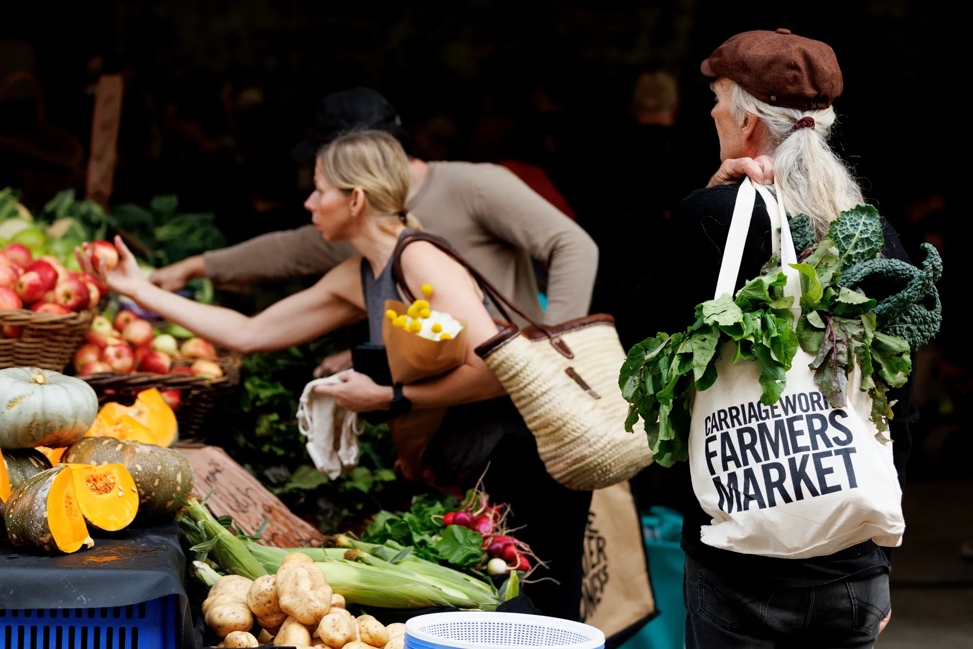Customers purchase produce from stalls at Carriageworks Farmers Market in Sydney, Australia.