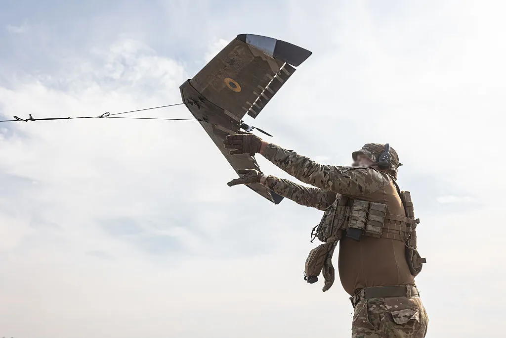 Ukrainian soldiers launch a reconnaissance drone.