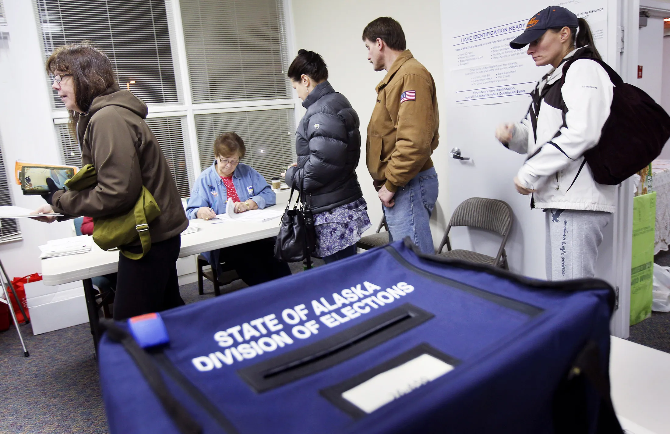 Alaskan voters line up to receive their ballots at a polling station in Anchorage on Nov. 2, 2010.
