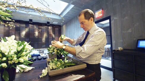 Charles Masson, director of Chevalier, arranges flowers.