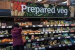 A worker replenishes items in the fresh produce section of a J Sainsbury&nbsp;supermarket in London.
