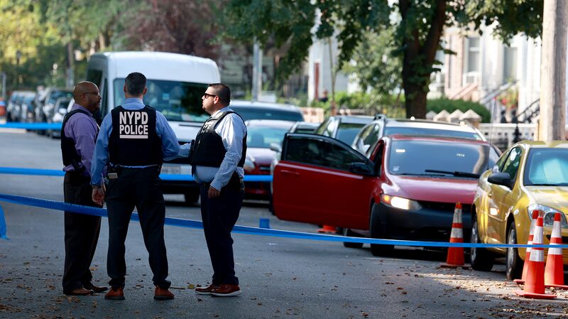Detectives look over the crime scene on North Henry Street where a crew member on “Law & Order: Organized Crime” was shot on July 19.