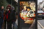 A woman walks past Coca-Cola digital advert. (Photo by Dinendra Haria / SOPA Images/Sipa USA)(Sipa via AP Images)