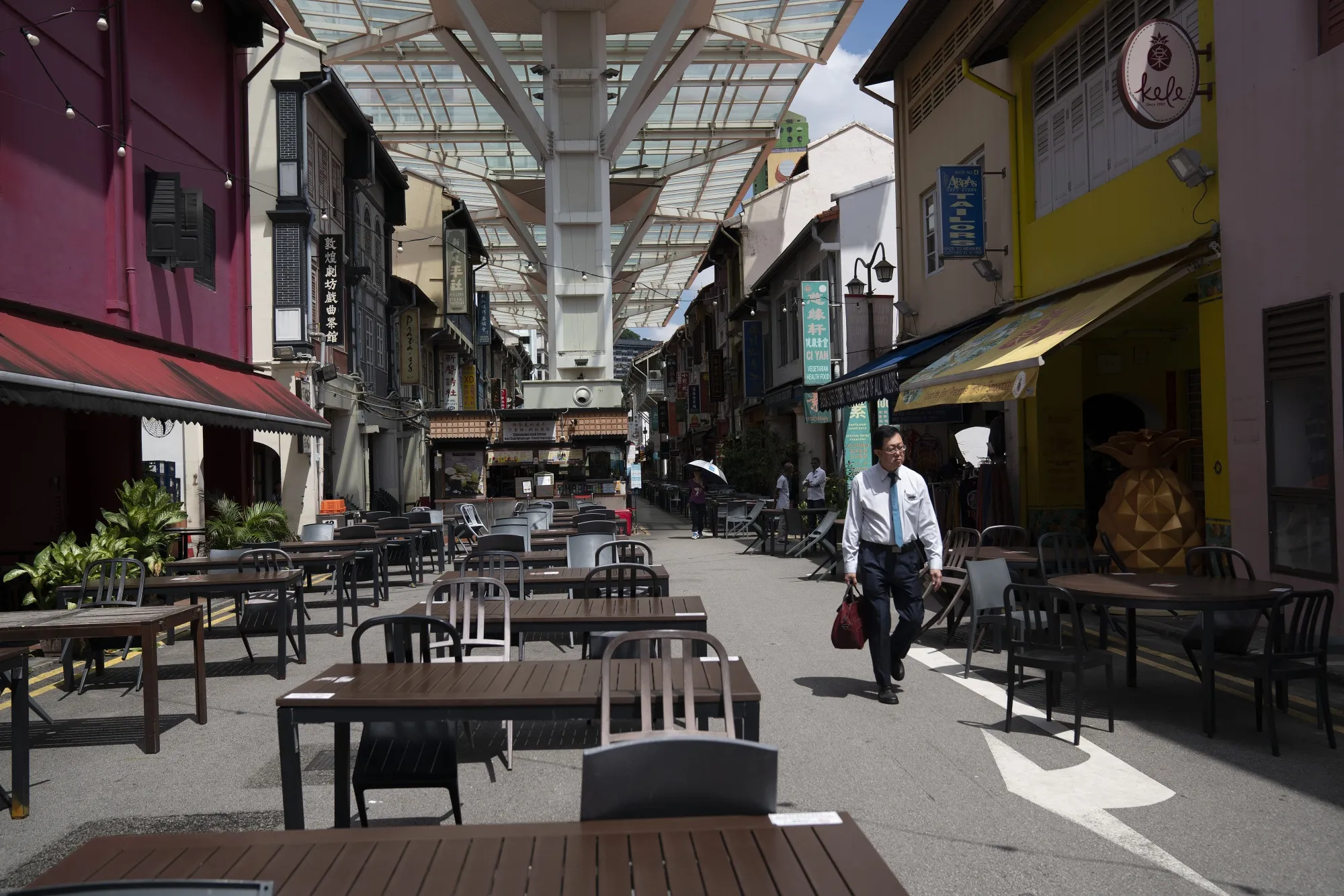 A pedestrian walks through the empty Chinatown Food Street in Singapore, March 24.