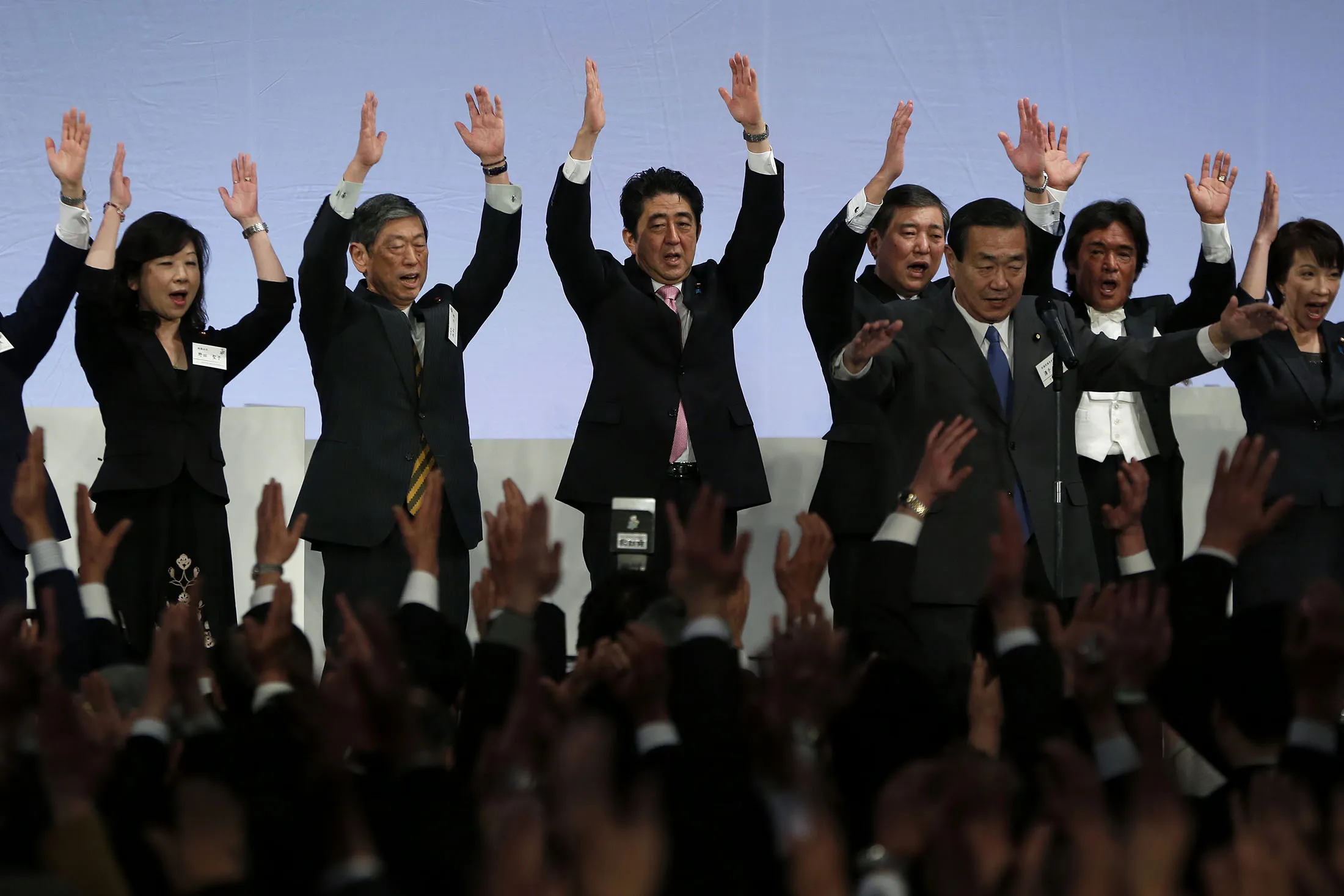Shinzo Abe and other Japanese political figures cheer during the Liberal Democratic Party's (LDP) annual convention in Tokyo, Japan in 2014.
