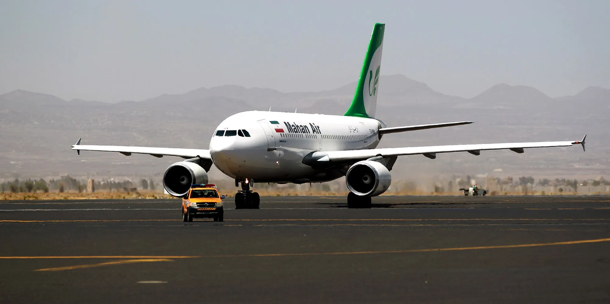 An airplane of Mahan Air sits at the tarmac after landing at Sanaa International Airport.