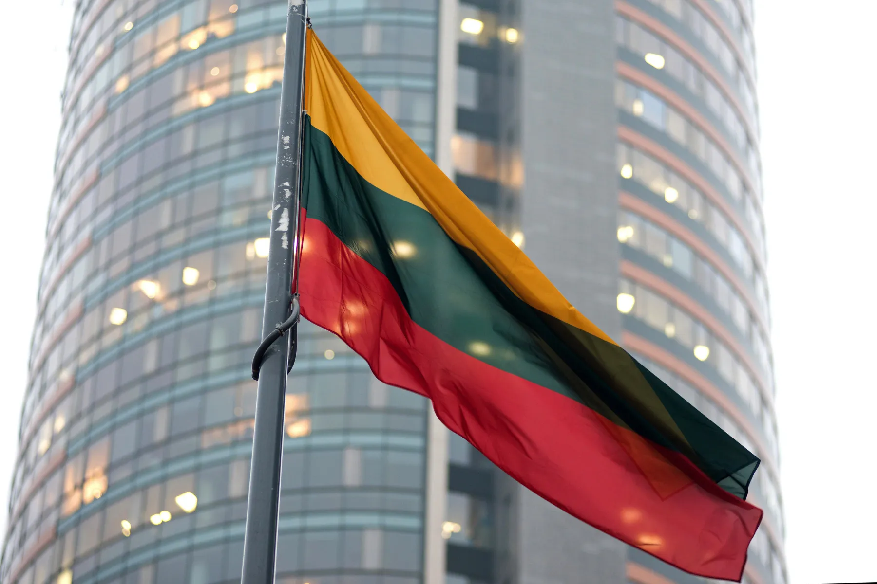 A Lithuanian national flag flies outside the Nasdaq OMX Vilnius Stock Exchange in Vilnius, Lithuania, on Tuesday, Dec. 16, 2014. Lithuania will switch currencies to the euro on Jan. 1, 2015.