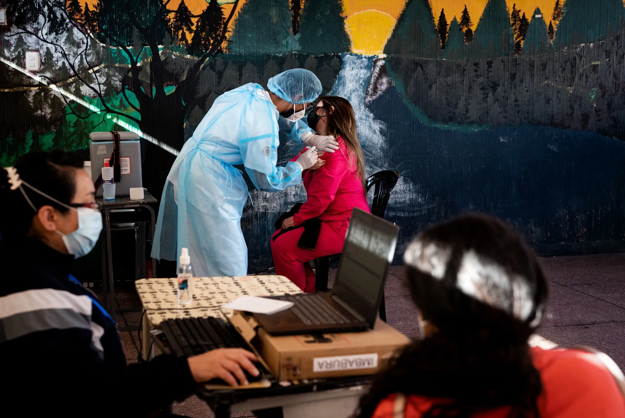 A healthcare workers administer a Covid-19 vaccine dose at a&nbsp;site in Quito, Ecuador.