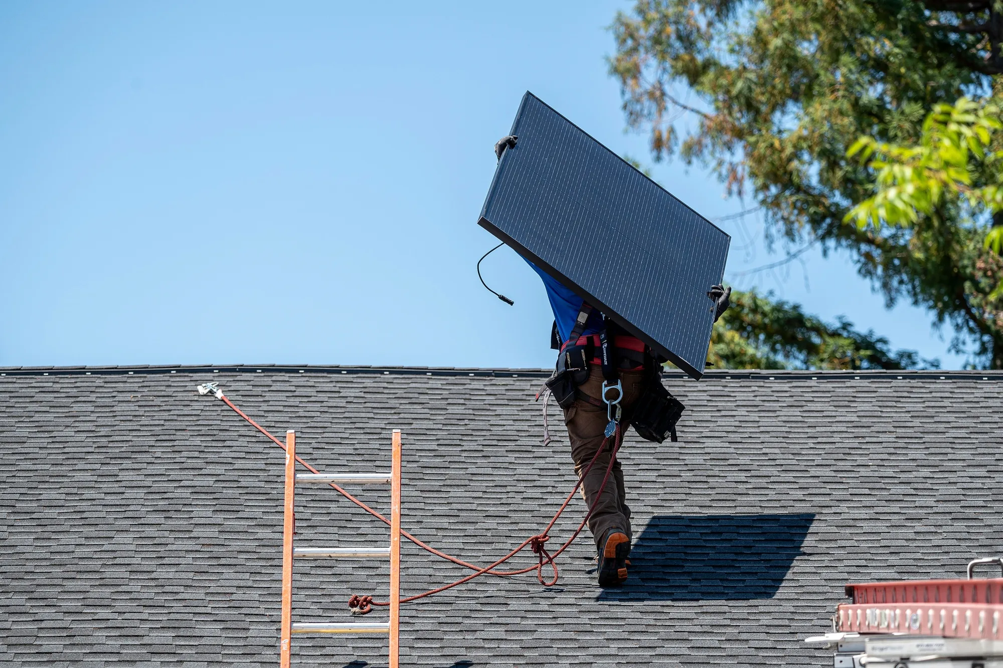A worker&nbsp;installs solar panels on a home in Napa, California.