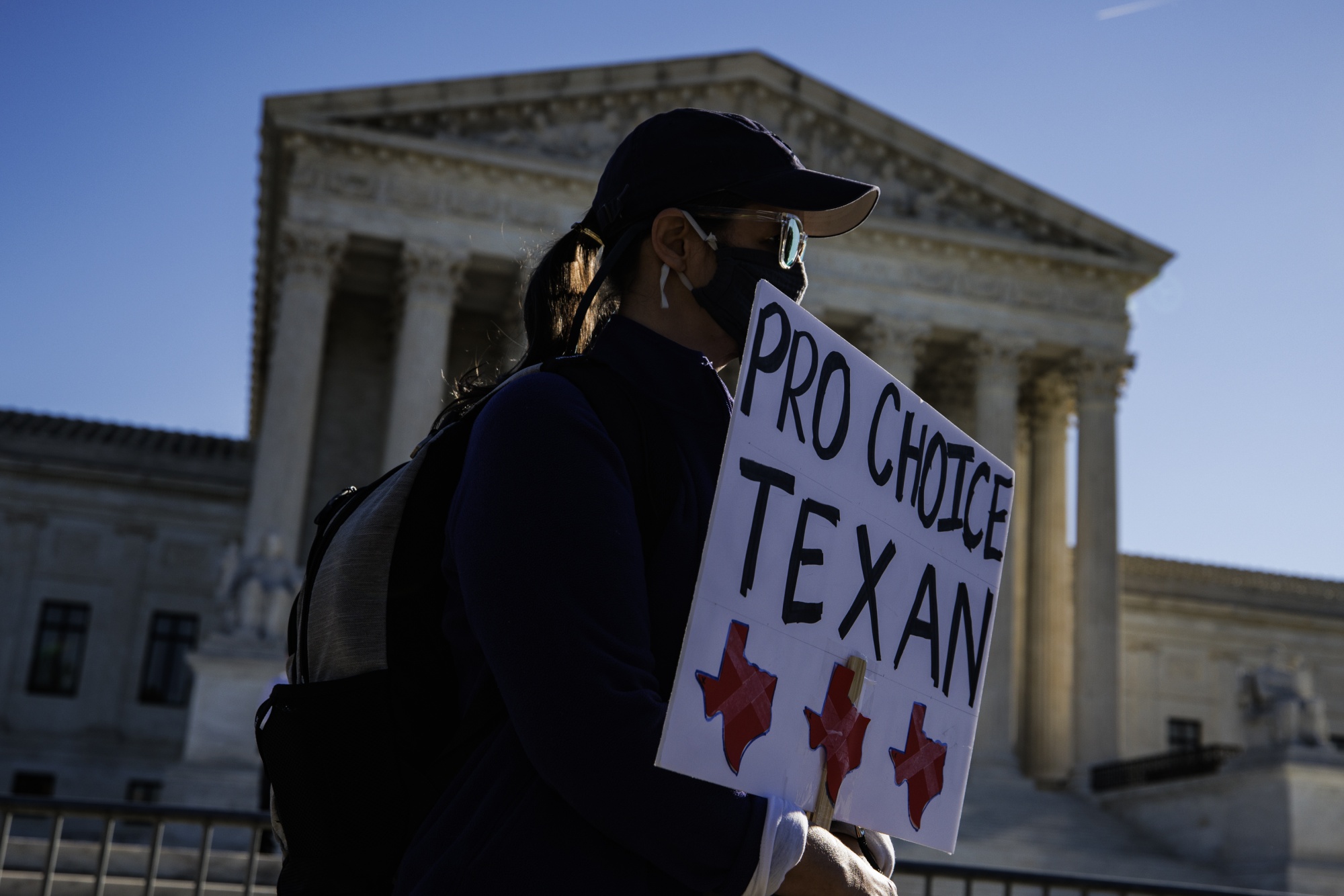 A demonstrator holds a sign outside the U.S. Supreme Court in Washington, D.C., in Nov. 2021.