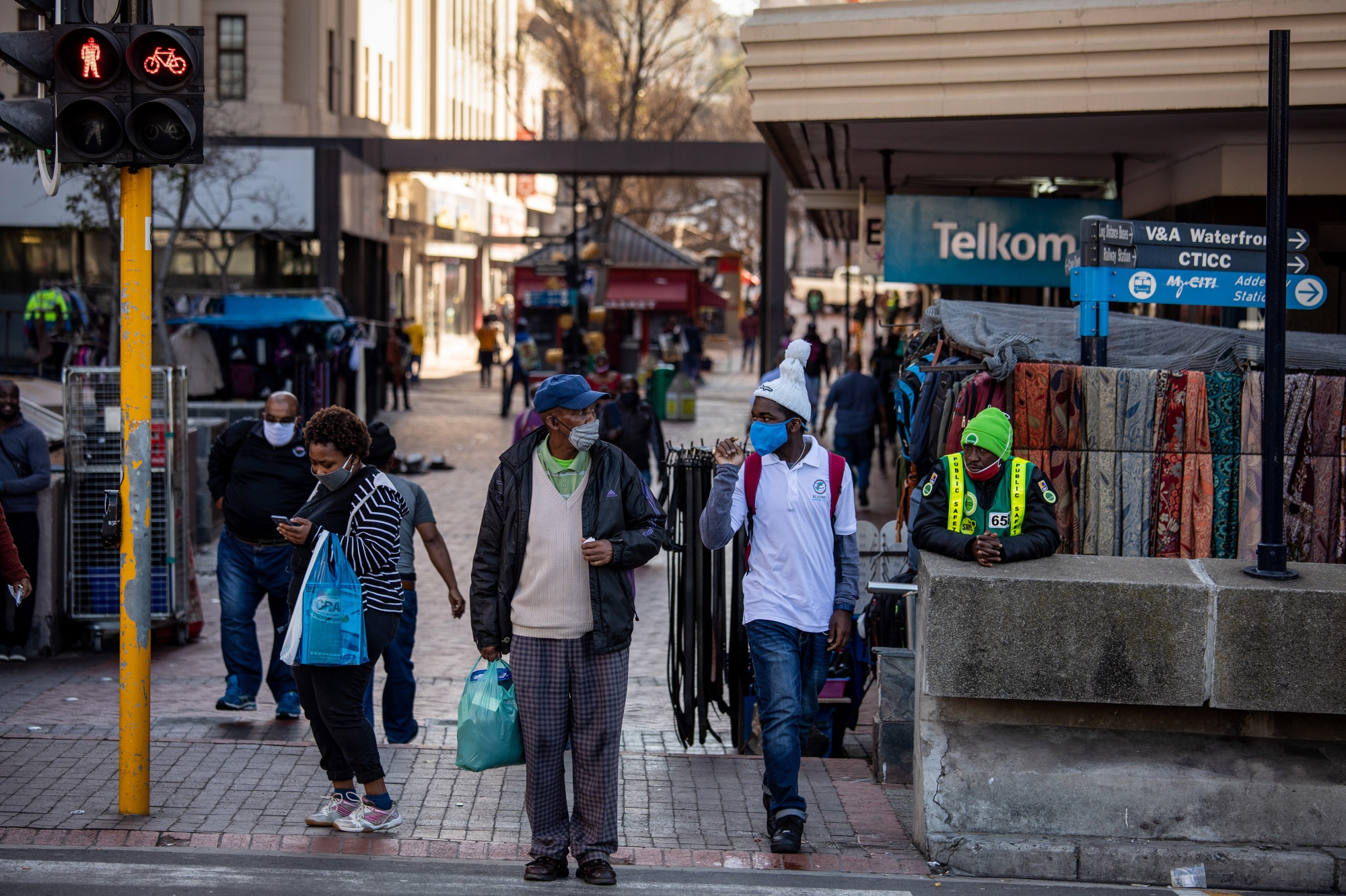 Pedestrians wait to cross Adderley Street in central Cape Town on July 23.