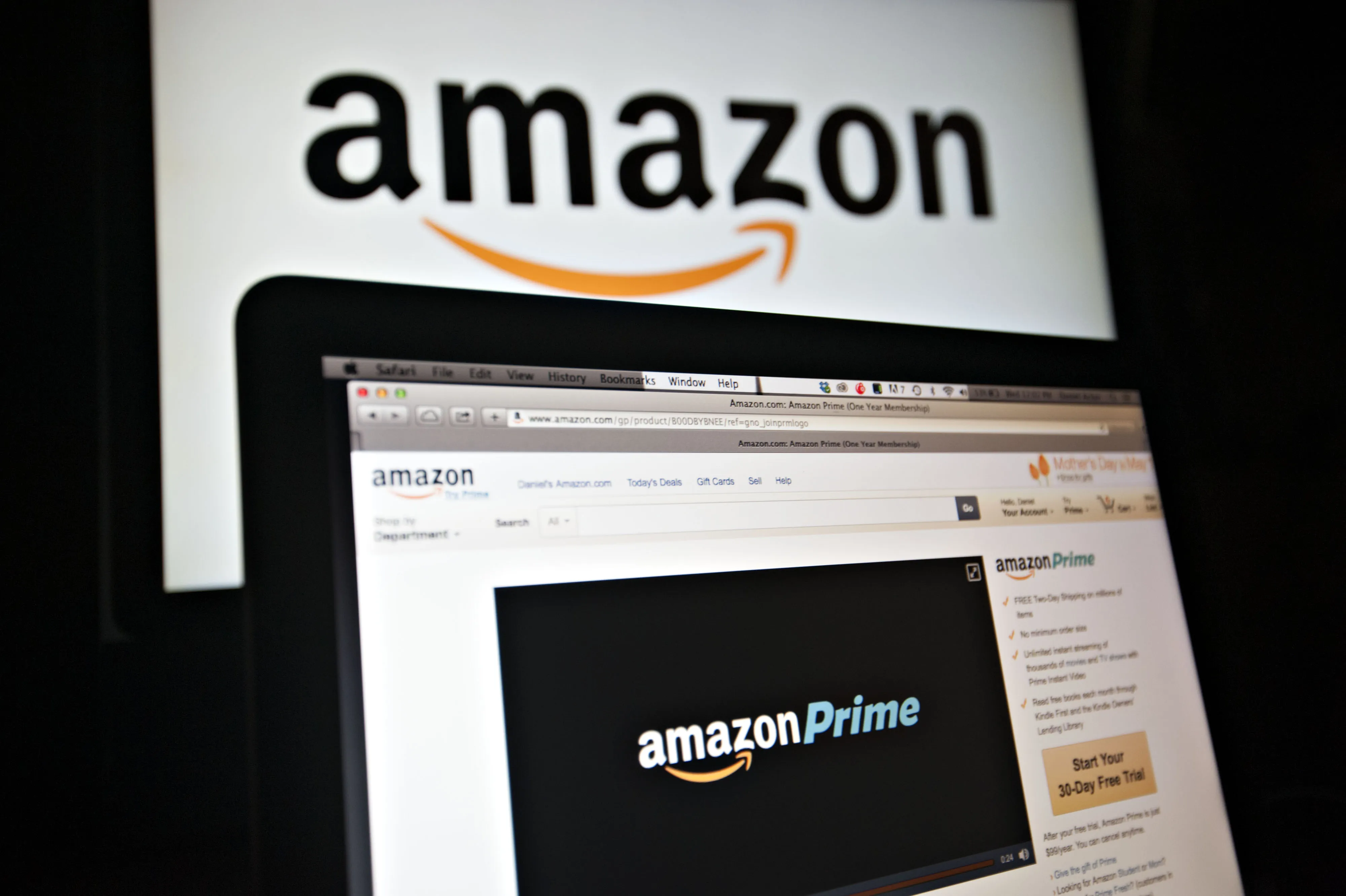 The Amazon.com Inc. Prime logo is displayed on computer screens.