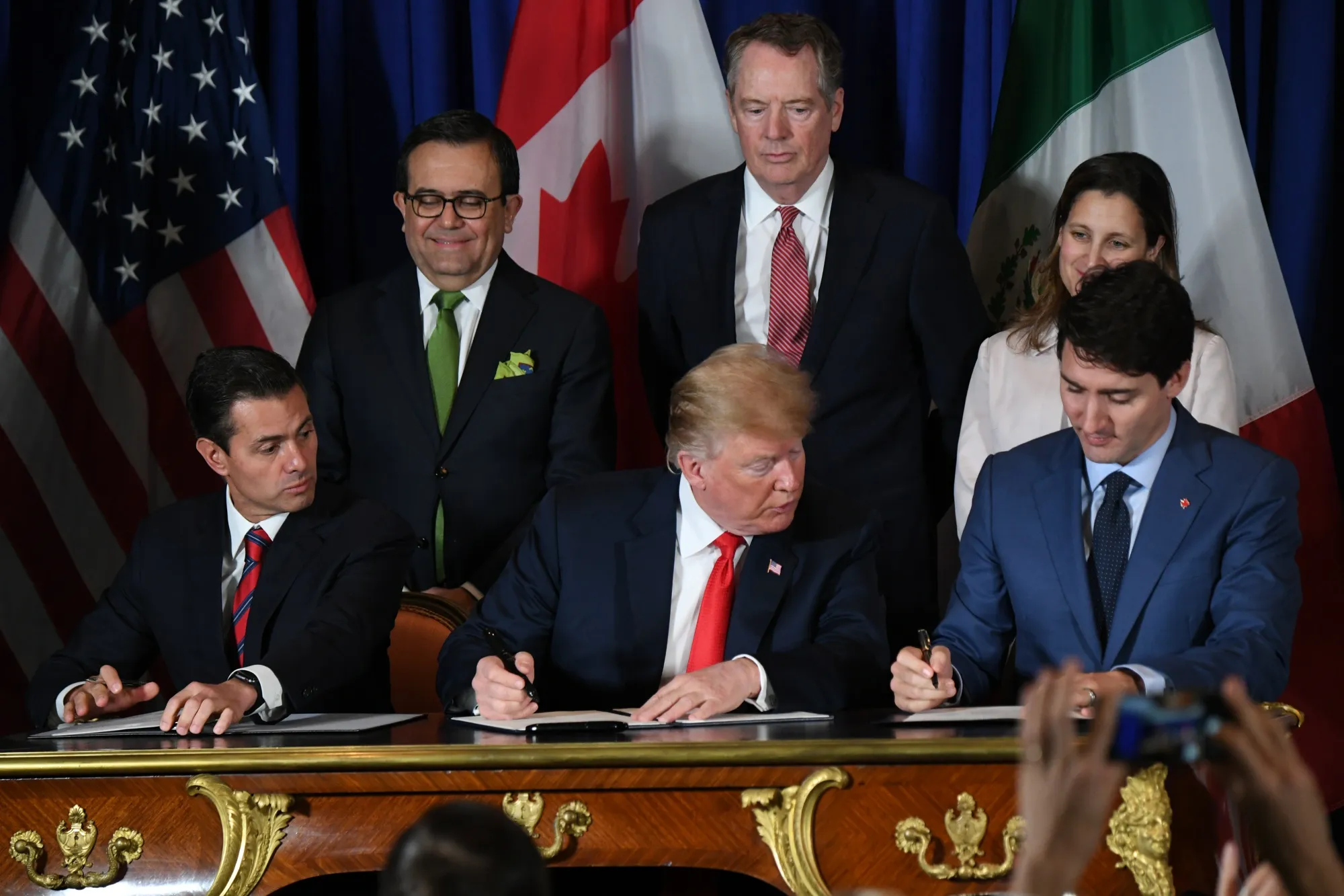 Enrique Pena Nieto, Donald Trump and Justin Trudeau&nbsp;sign a new free trade agreement in Buenos Aires&nbsp;on Nov. 30.