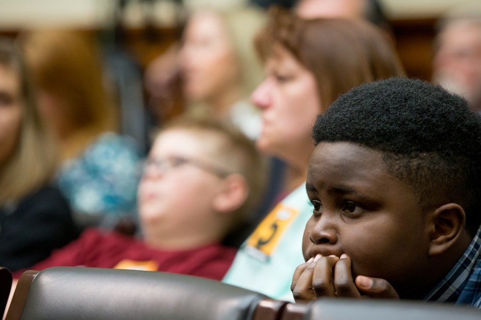 Flint resident Jaylon Terry, 10, right, and other Flint residents sit in the audience during a House Oversight and Government Reform Committee hearing on the Flint water crisis. 