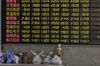 Lunch boxes and bottles sit in front of an electronic stock board at a securities brokerage in Shanghai, China, on Wednesday, May 30, 2018. Foreign investors are about to get a bargain. At least, that's the optimistic slant after Chinese equities slumped for the longest stretch since 2013, taking valuations back to two-year lows right before they feature on MSCI Inc. indexes from June 1.