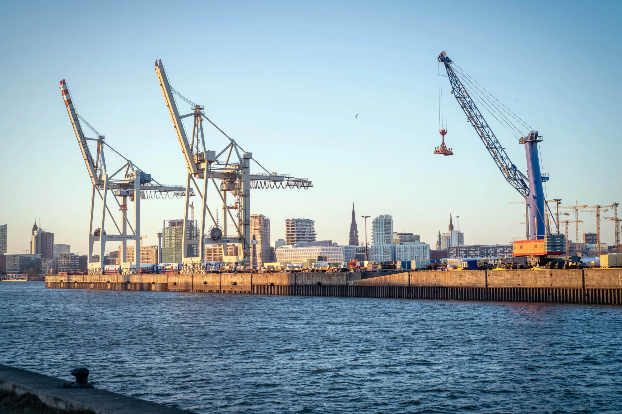 Cranes at the Port of Hamburg in the Altona area of Hamburg, Germany, on Friday, March 11, 2022. Germany's maritime traffic is likely to take a hit from sanctions on Russia, the Federal Statistics Office said this week, data through November show the country was German seaports most important partner in 2021, ahead of Sweden and China.