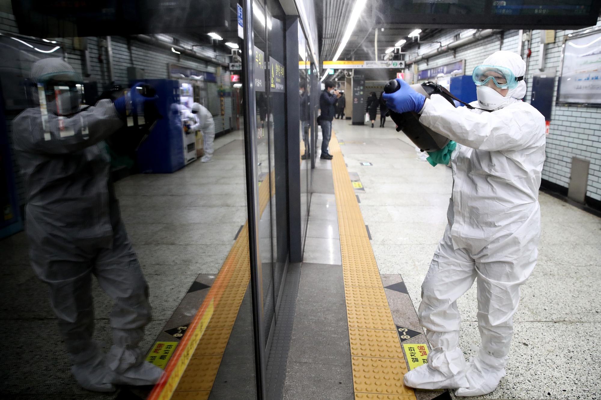 A health worker sprays&nbsp;disinfection at a rail station in&nbsp;Seoul, on Feb. 21.