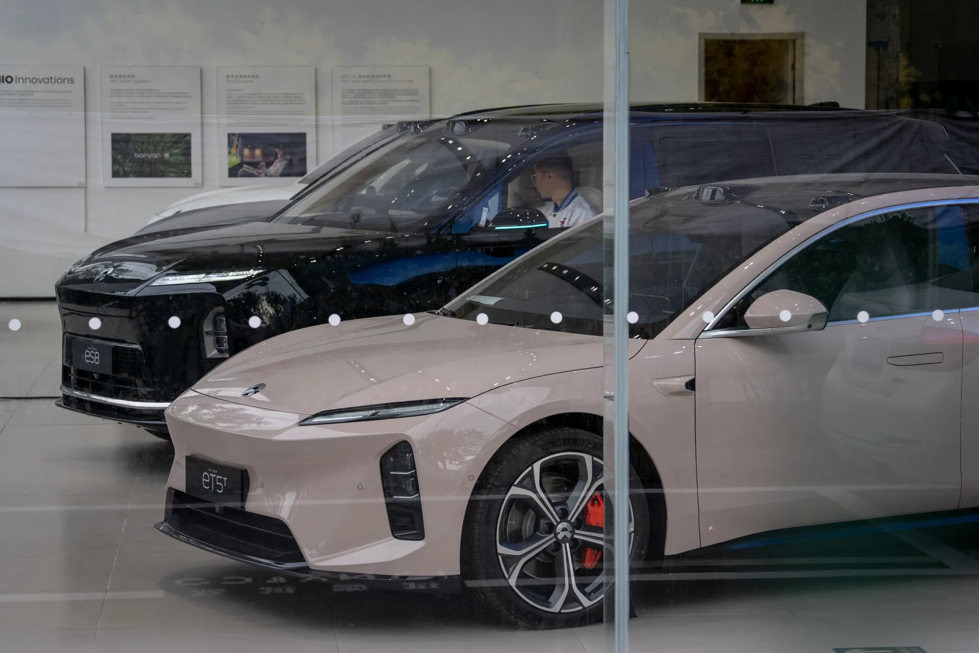 A NIO Inc. ET5T and an ES8 electric vehicles on display at the company's showroom in Beijing.