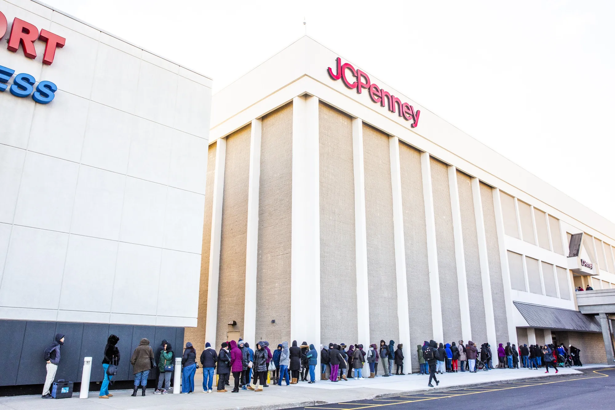 Shoppers stand in line waiting for a J.C. Penney Co. store to open their doors.