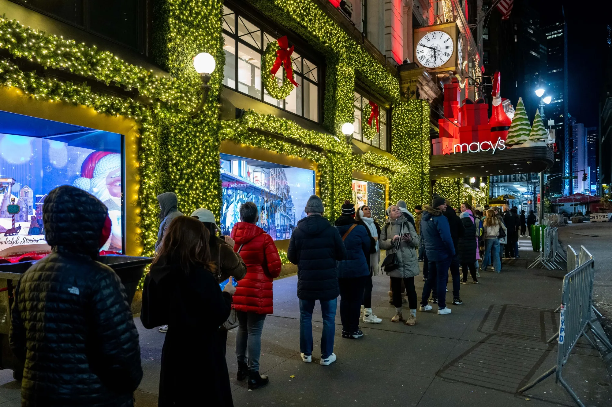 Shoppers wait in line outside a store in Herald Square before opening on Black Friday in New York on Nov. 28.