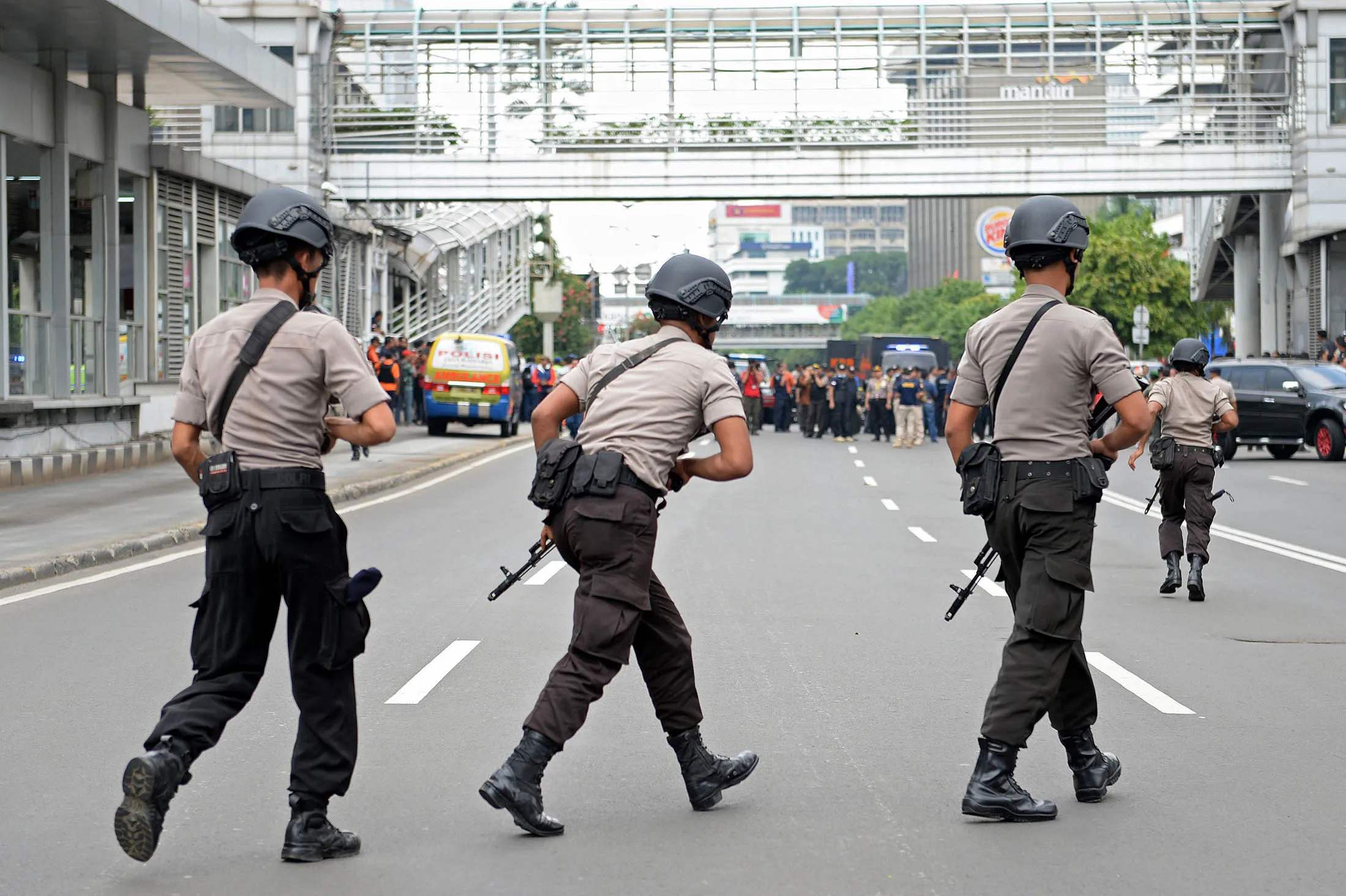 Armed police officers cross a road near the site of an explosion in Jakarta, Indonesia, on Thursday, Jan. 14.
